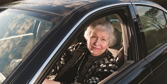 Woman in the driver's seat of a sedan